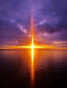 Image of a bright sunrise over the ocean.